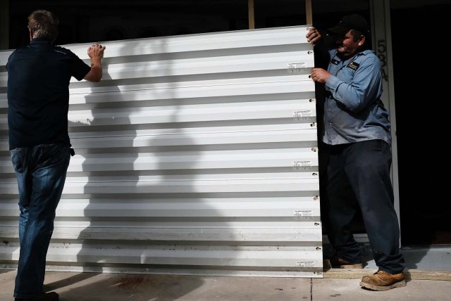 NAPLES, FL - SEPTEMBER 09: Metal siding is placed in front of a business in downtown Naples before the arrival of Hurricane Irma into Southwest Florida on September 9, 2017 in Naples, Florida. The Naples area could begin to feel hurricane-force winds from Irma by 11 a.m. Sunday and experience wind gusts over 100 mph from Sunday through Monday.   Spencer Platt/Getty Images/AFP