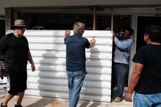 NAPLES, FL - SEPTEMBER 09: Metal siding is placed in front of a business in downtown Naples before the arrival of Hurricane Irma into Southwest Florida on September 9, 2017 in Naples, Florida. The Naples area could begin to feel hurricane-force winds from Irma by 11 a.m. Sunday and experience wind gusts over 100 mph from Sunday through Monday.   Spencer Platt/Getty Images/AFP