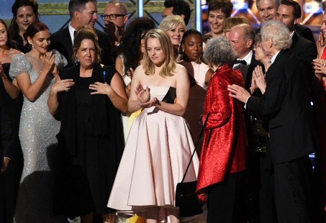 LOS ANGELES, CA - SEPTEMBER 17: Actor Elisabeth Moss (L) and author Margaret Atwood with cast and crew of 'The Handmaid's Tale' accept the Outstanding Drama Series award onstage during the 69th Annual Primetime Emmy Awards at Microsoft Theater on September 17, 2017 in Los Angeles, California.   Kevin Winter/Getty Images/AFP