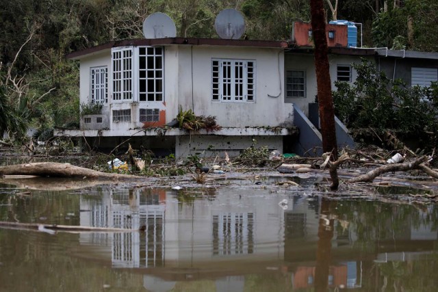 A house submerged by flood waters is seen close to the dam of the Guajataca lake after the area was hit by Hurricane Maria in Guajataca, Puerto Rico September 23, 2017. REUTERS/Carlos Garcia Rawlins