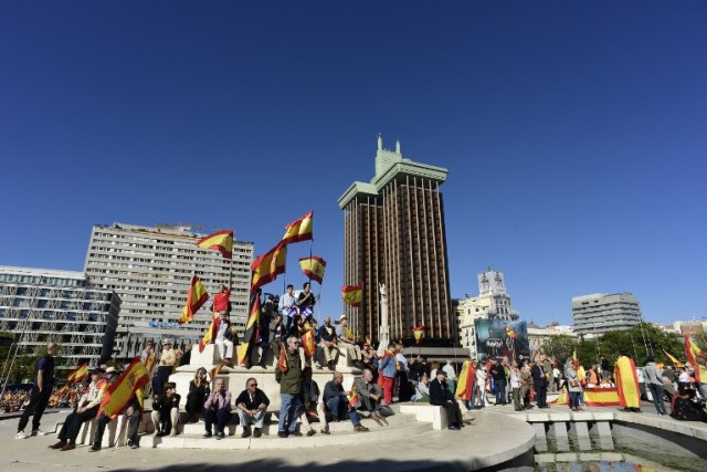 La gente agita banderas españolas durante una manifestación llamando a la unidad en la Plaza de Colón en Madrid el 28 de octubre de 2017, un día después de que se impuso el control directo sobre Cataluña en un intento por separarse de España. España se movió para afirmar el dominio directo sobre Cataluña, reemplazando a sus funcionarios ejecutivos y altos para sofocar un impulso de independencia que ha sumido al país en una crisis y ha puesto nerviosa a la Europa secesionista. / AFP PHOTO / JAVIER SORIANO