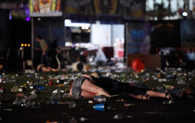 LAS VEGAS, NV - OCTOBER 01: (EDITORS NOTE: Image contains graphic content.) A person lies on the ground covered with blood at the Route 91 Harvest country music festival after apparent gun fire was heard on October 1, 2017 in Las Vegas, Nevada. There are reports of an active shooter around the Mandalay Bay Resort and Casino. David Becker/Getty Images/AFP