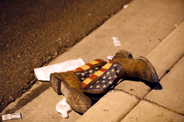 A pair of cowboy boots is shown in the street outside the concert venue after a mass shooting at a music festival on the Las Vegas Strip in Las Vegas, Nevada, U.S. October 1, 2017. REUTERS/Las Vegas Sun/Steve Marcus