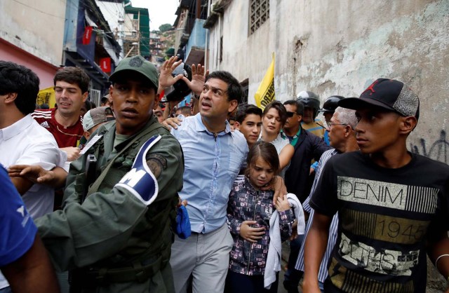 Carlos Ocariz, candidate for the Venezuelan coalition of opposition parties (MUD), is saluted by supporters as he arrives at a polling station to cast his vote during a nationwide election for new governors in Caracas, Venezuela, October 15, 2017. REUTERS/Carlos Garcia Rawlins