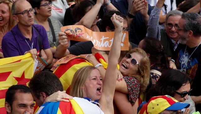 People react as they watch on giant screens a plenary session outside the Catalan regional parliament in Barcelona, Spain, October 27, 2017. REUTERS/Yves Herman