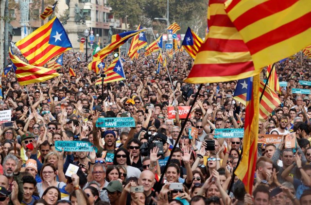 People react while the Catalan regional parliament votes for independence of Catalonia from Spain in Barcelona, Spain October 27, 2017. REUTERS/Yves Herman