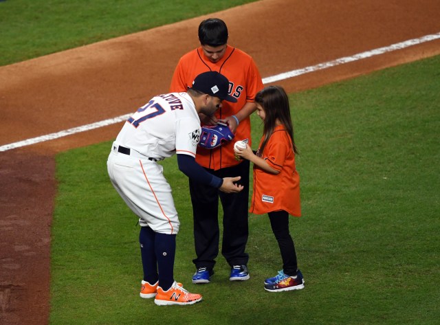 Hailey Dawson (derecha) saluda al segunda base de los Astros de Houston José Altuve (27) después de lanzar para el primer lanzamiento ceremonial antes del cuarto partido de la Serie Mundial 2017 entre los Astros de Houston y los Dodgers de Los Ángeles en el Minute Maid Park. Crédito obligatorio: Shanna Lockwood-USA TODAY Sports