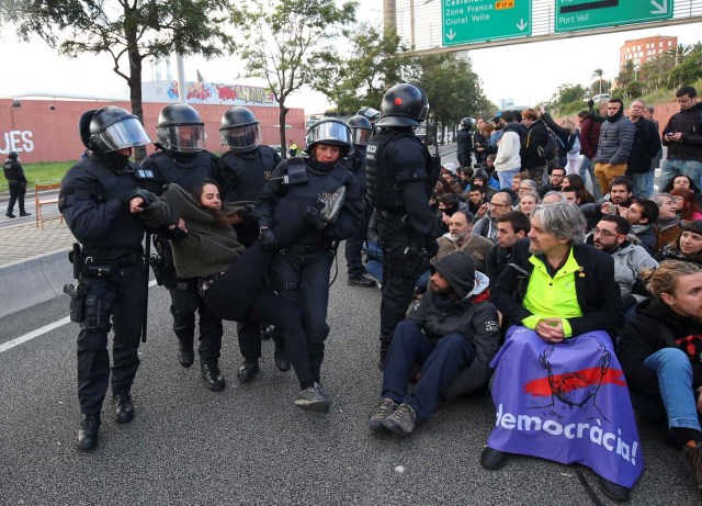 Police remove protestors blocking a ring road in Barcelona during a partial regional strike called by pro-independence parties and labour unions in Barcelona, Spain, November 8, 2017. REUTERS/Albert Gea