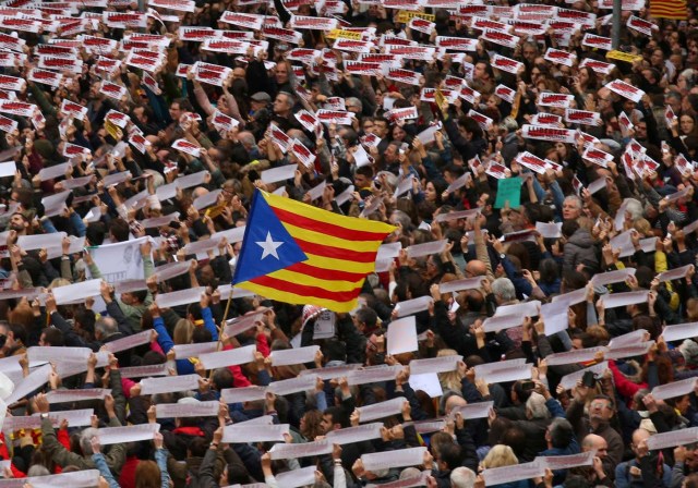 Protesters hold banners reading "Freedom Political Prisoners, We are Republic" as they gather in Sant Jaume square at a demonstration during a partial regional strike in Barcelona, Spain, November 8, 2017. REUTERS/Albert Gea TPX IMAGES OF THE DAY