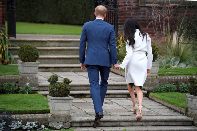 Britain's Prince Harry poses with Meghan Markle in the Sunken Garden of Kensington Palace, London, Britain, November 27, 2017. REUTERS/Toby Melville