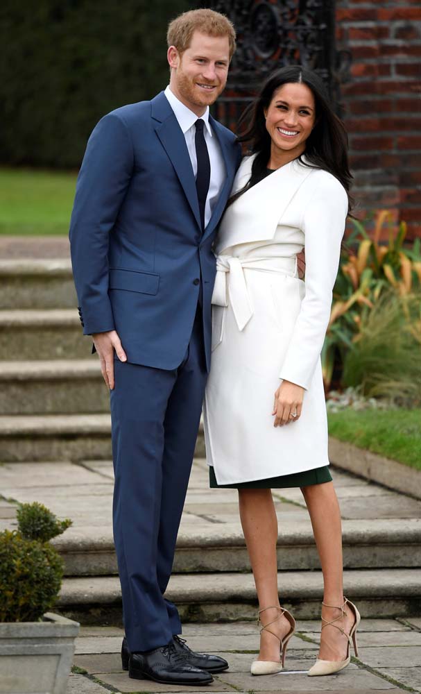 Britain's Prince Harry poses with Meghan Markle in the Sunken Garden of Kensington Palace, London, Britain, November 27, 2017. REUTERS/Toby Melville