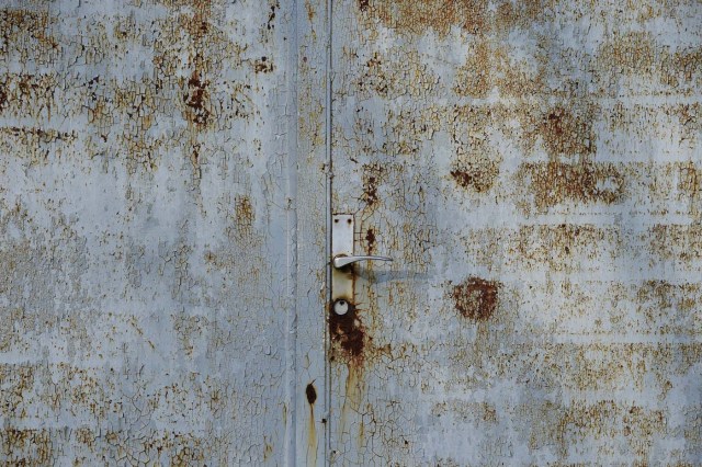 A door of a house is pictured in Alwine, a splinter settlement of the town Uebigau-Wahrenbrueck, eastern Germany, on November 30, 2017. On December 9, 2017, Alwine's dozen buildings, plus sheds and garages, are to go under the hammer at an auction in Berlin, with a starting price of 125,000 euros ($148,000). / AFP PHOTO / Tobias Schwarz