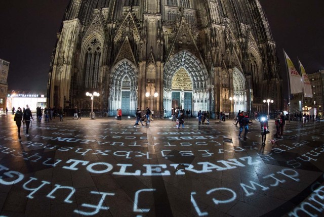 "Tolerance" and other words are being displayed on the ground in front of the Cologne Cathedral on December 30, 2017 in Cologne, western Germany, as part of a light installation by artist Ingo Dietzel. The artist collects wishes from people and integrates them in his work that will be displayed during New Year's Eve celebrations in front of Cologne's most famous landmark, the Cathedral. / AFP PHOTO / dpa / Rainer Jensen / Germany OUT