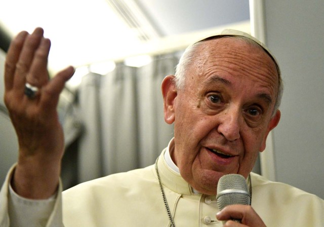 Pope Francis gestures during a news conference on board REUTERS/Vincenzo Pinto/Pool