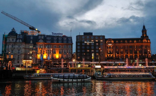 Touristic boats are illuminated while cruising on a canal in central Amsterdam, Netherlands, November 30, 2017. Picture taken November 30, 2017. REUTERS/Yves Herman