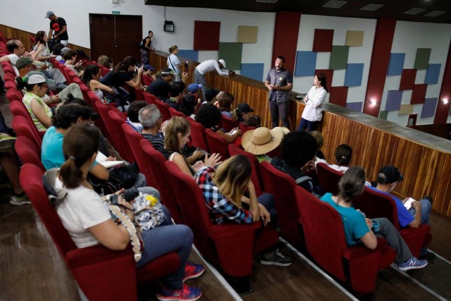 Luis Bergolla (standing C), tour organizer of 'Caracas in 365', speaks to attendees inside the Catia Theater during a walking tour at Catia neighborhood in Caracas, Venezuela November 18, 2017. Picture taken November 18, 2017. REUTERS/Marco Bello