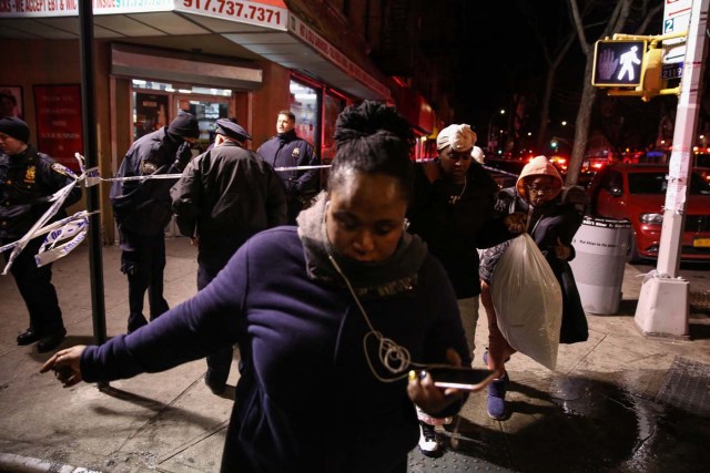 New York Police Department (NYPD) officers stand guard during an evacuation following a fire at an apartment building in Bronx, New York, U.S. December 28, 2017. REUTERS/Amr Alfiky