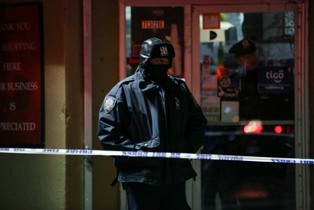 New York Police Department (NYPD) officers stand guard during an evacuation following a fire at an apartment building in Bronx, New York, U.S. December 28, 2017. REUTERS/Amr Alfiky