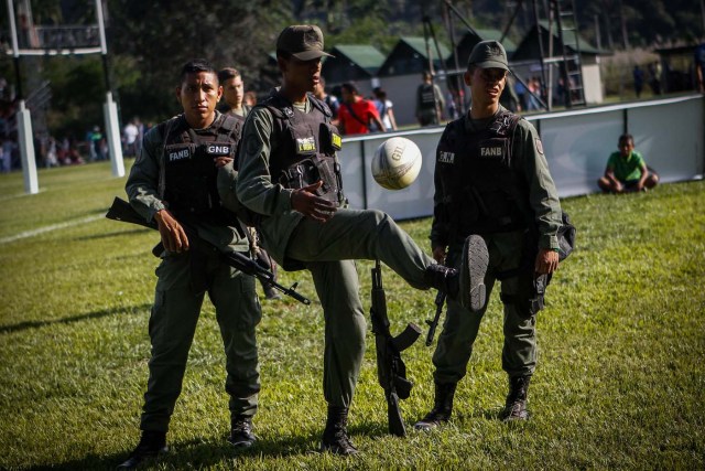 ACOMPAÑA CRÓNICA: RUGBY VENEZUELA - CAR101. MARACAY (VENEZUELA), 02/12/2017.- Fotografía del viernes 1 de diciembre de 2017, que muestra a soldados custodios mientras juegan con un balón durante un torneo de Rugby entre equipos conformados por internos de ocho prisiones venezolanas en la Hacienda Santa Teresa, sede de la compañía manufacturera de Ron del mismo nombre en Maracay (Venezuela). EFE/Cristian Hernández