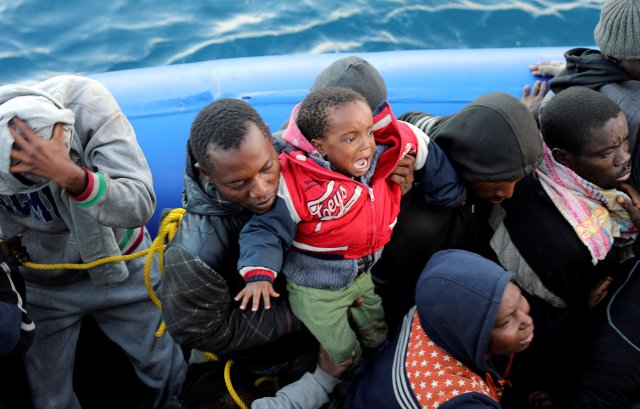 Migrants in a dinghy are rescued by Libyan coast guards off the coast of Garabulli, east of Tripoli, Libya, January 8, 2018. REUTERS/Hani Amara