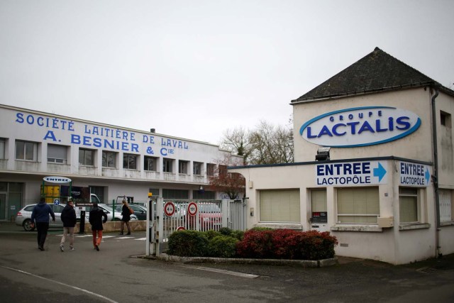 Employees walk in front of the entrance of the French dairy group Lactalis headquarters in Laval, western France, January 12, 2018. REUTERS/Stephane Mahe