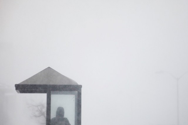 A man waits for a bus during a blizzard in Long Beach, New York, U.S. January 4, 2018. REUTERS/Shannon Stapleton