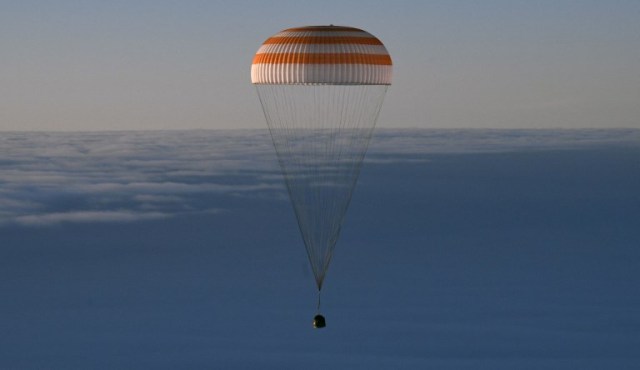 La cápsula espacial Soyuz MS-06 que transporta el equipo de la Estación Espacial Internacional (ISS) del cosmonauta ruso Alexander Misurkin y los astronautas de la NASA Mark Vande Hei y Joe Acaba desciende debajo de un paracaídas antes de aterrizar en un área remota fuera de la ciudad de Dzhezkazgan (Zhezkazgan), Kazajstán , el 28 de febrero de 2018. / AFP PHOTO / POOL / ALEXANDER NEMENOV