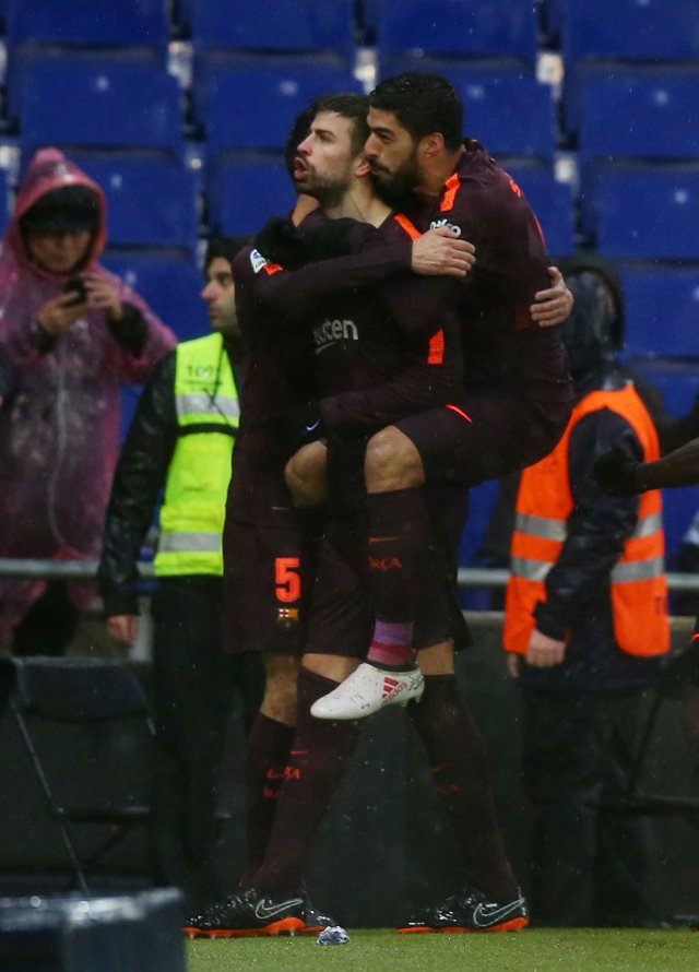 Soccer Football - La Liga Santander - Espanyol vs FC Barcelona - RCDE Stadium, Barcelona, Spain - February 4, 2018 Barcelona’s Gerard Pique celebrates with Luis Suarez after scoring their first goal REUTERS/Albert Gea