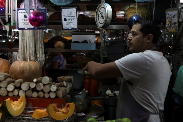 Information for Vippo app is seen in a fruit and vegetables stall at Chacao Municipal Market in Caracas, Venezuela January 19, 2018. Picture taken January 19, 2018. REUTERS/Marco Bello