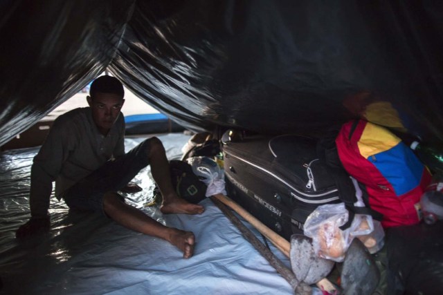 (FILES) In this file photo taken on February 25, 2018 A Venezuelan refugee takes rest inside the improvised refugee camp in the Simon Bolivar square, Boa Vista, Roraima, Brazil, on February 25, 2018. According to local authorities, around one thousand refugees are crossing the Brazilian border each day from Venezuela. With the constant influx of Venezuelan immigrants, most are living in shelters and the streets of Boa Vista and Pacaraima cities, looking for work, medical care and food. Most are legalizing their status to stay and live in Brazil. / AFP PHOTO / Mauro PIMENTEL / TO GO WITH AFP STORY