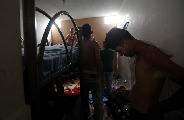 Venezuelans stand in a room at a shelter for Venezuelans in San Juan de Lurigancho, on the outskirts of Lima, Peru March 9, 2018. REUTERS/Mariana Bazo