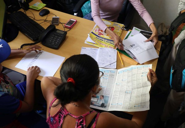 A Venezuelan migrant checks a newspaper with job offers at a shelter for Venezuelans in San Juan de Lurigancho, on the outskirts of Lima, Peru March 9, 2018. REUTERS/Mariana Bazo