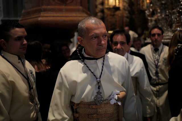 Spanish actor Antonio Banderas looks on inside a church before taking part as a penitent in the "Lagrimas and Favores" brotherhood, during a Palm Sunday procession in Malaga, Spain March 25, 2018. REUTERS/Jon Nazca