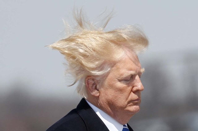 U.S. President Donald Trump boards Air Force One on a windy day at Joint Base Andrews, Maryland before departing en route West Virginia, U.S., April 5, 2018. REUTERS/Kevin Lamarque