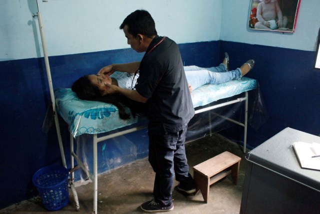 A woman receives a medical check during a health campaign in Puerto Nuevo , Venezuela April 9, 2018. Picture taken April 9, 2018. REUTERS/Carlos Eduardo Ramirez