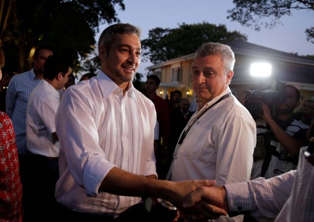 Paraguayan presidential candidate Mario Abdo Benitez of the Colorado Party shakes hands with members of the media at his house, during national election in Asuncion, Paraguay April 22, 2018. REUTERS/Jorge Adorno