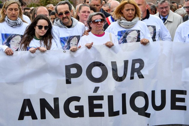 Angelique's mother (C), father (3rdL) and sister Anais (2ndL), take part in a march in Wambrechies, northern France, on May 1, 2018, in tribute to Angelique, a 13-year-old girl who was killed and raped on April 25. The body of Angelique, who had disappeared since April 25, was found in the night from April 28 to April 29 in the countryside in Quesnoy-sur-Deule, northern France. David Ramault, 45 years old, who confessed the crime, was arrested in the night from April 30 to May 1 for kidnapping, rape and murder on minor under 15 years / AFP PHOTO