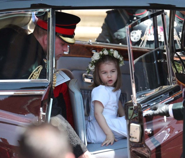 Prince Harry's brother and best man Prince William, Duke of Cambridge (L) and his daughter Princess Charlotte of Cambridge leave after attending the wedding ceremony of Britain's Prince Harry, Duke of Sussex and US actress Meghan Markle at St George's Chapel, Windsor Castle, in Windsor, on May 19, 2018. / AFP PHOTO / POOL / Jane Barlow