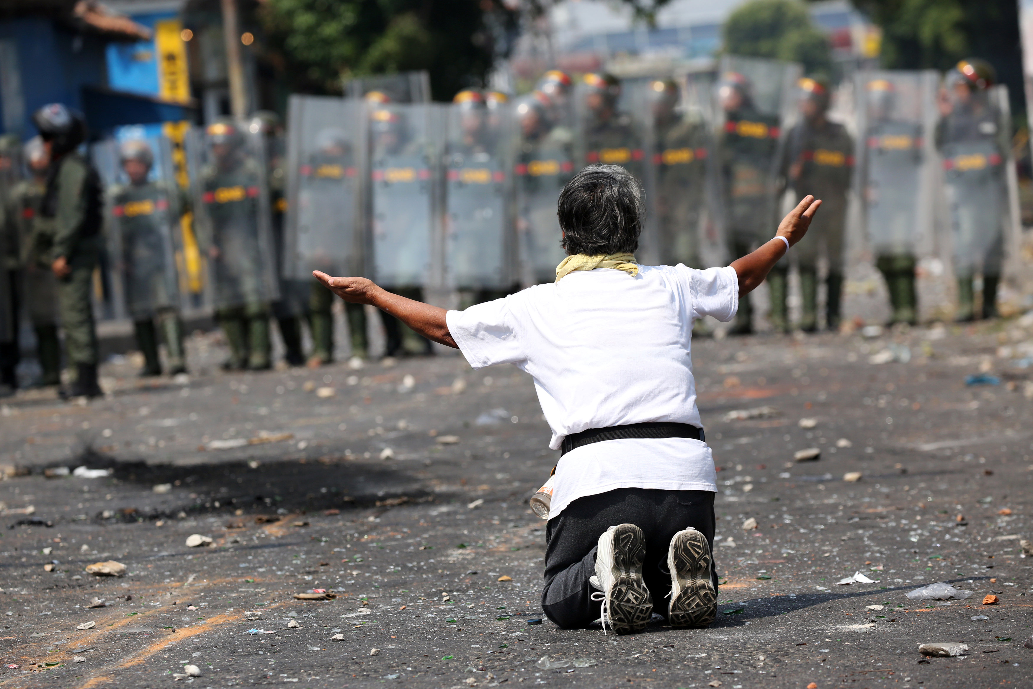 LA FOTO: Mujer de rodilla ante la GNB clama ingreso de la ayuda humanitaria en Ureña